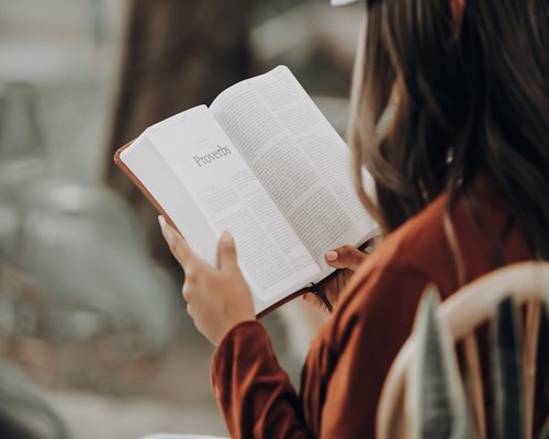 Person relaxing reading a book on the weekend